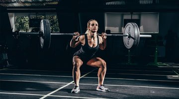 Female Athlete Doing a Barbell Squat